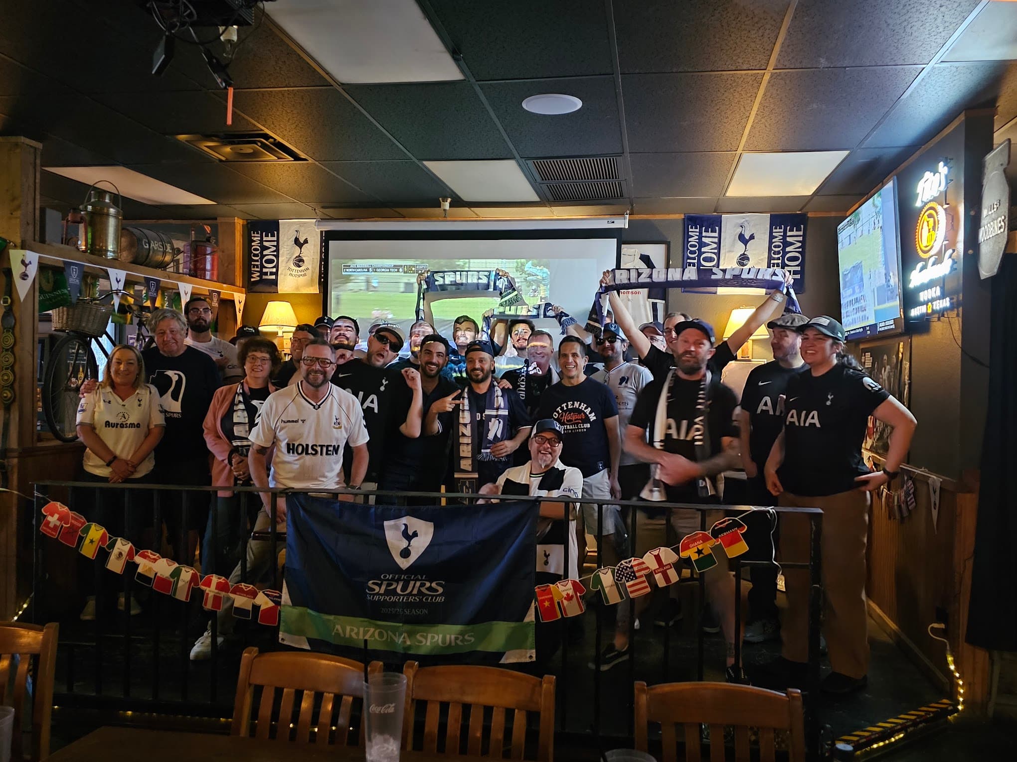 Arizona Spurs members gathered at Fibber Magee's Pub for a watch party, holding club and Tottenham Hotspur scarves